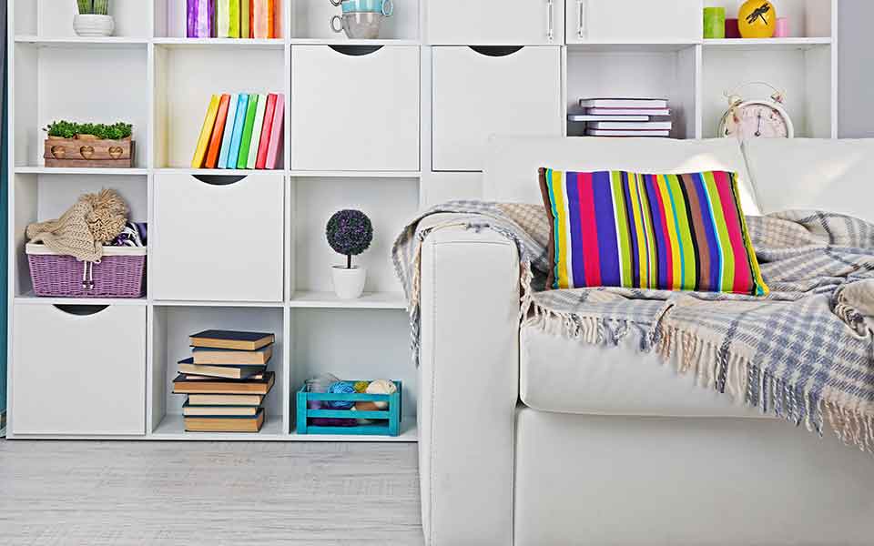 White sofa in front of shelves