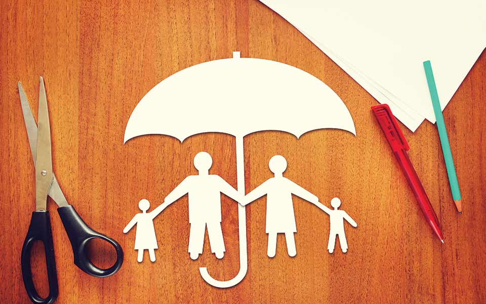 Cutout paper family under an umbrella