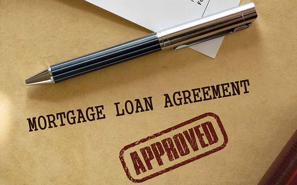 Pen resting on approved mortgage form