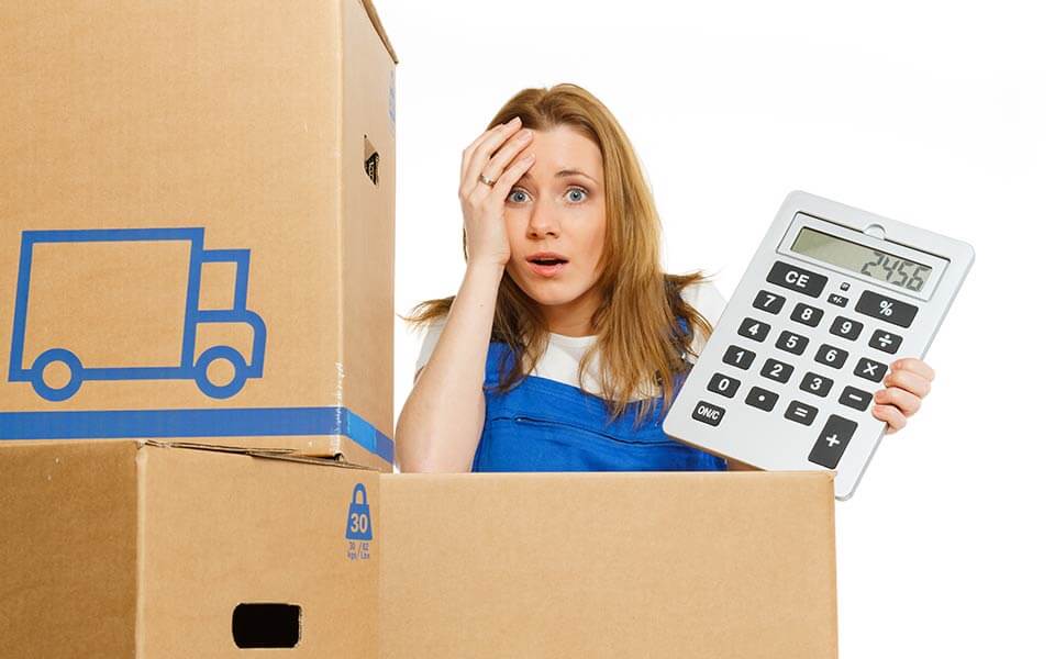 Woman with moving boxes holding a big calculator