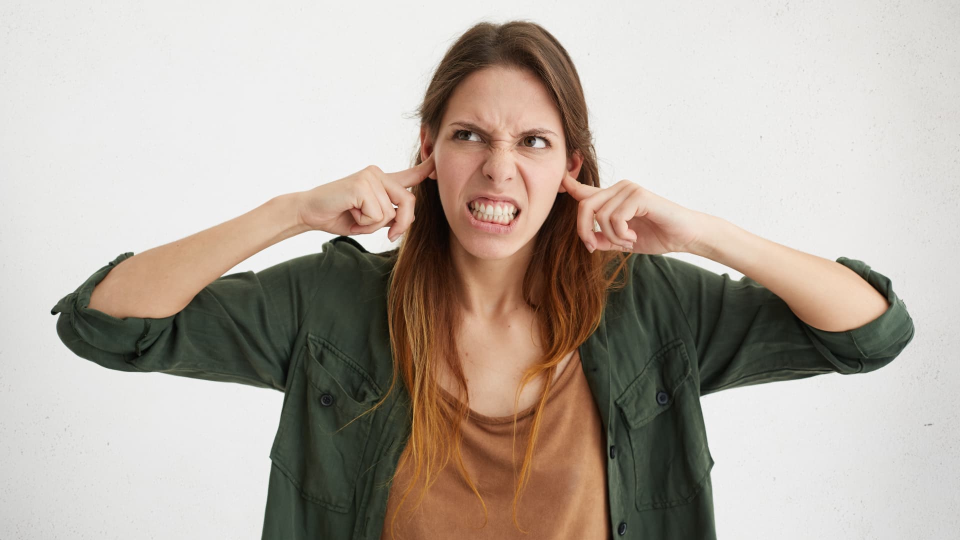 Woman covering her ears