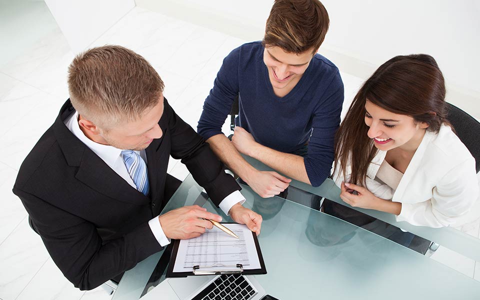 three people reading a checklist