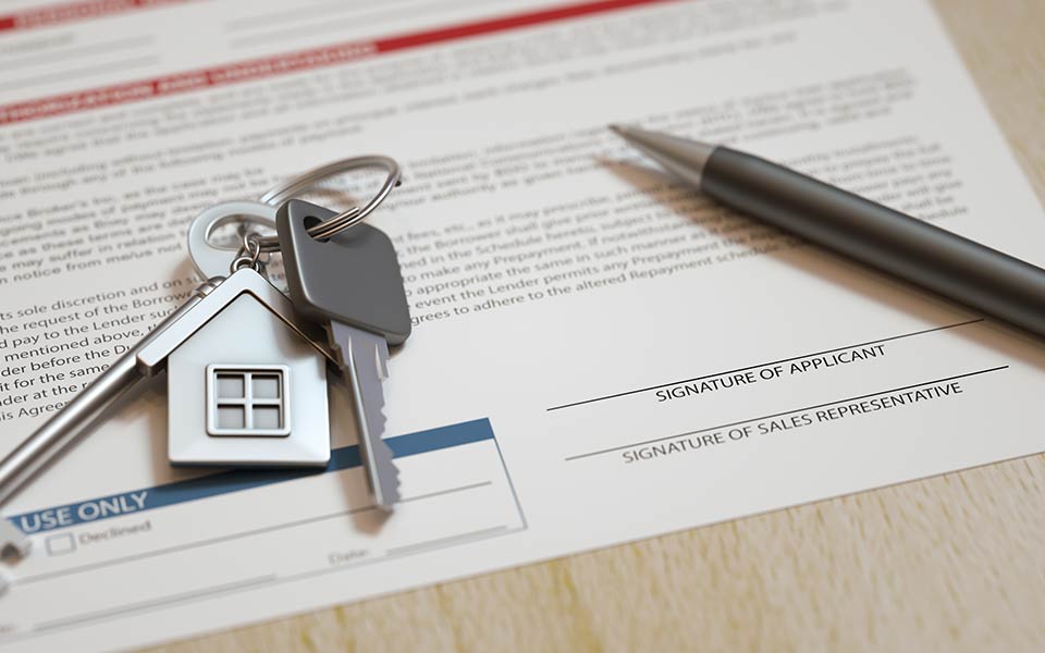 set of keys on top of contract with signature box